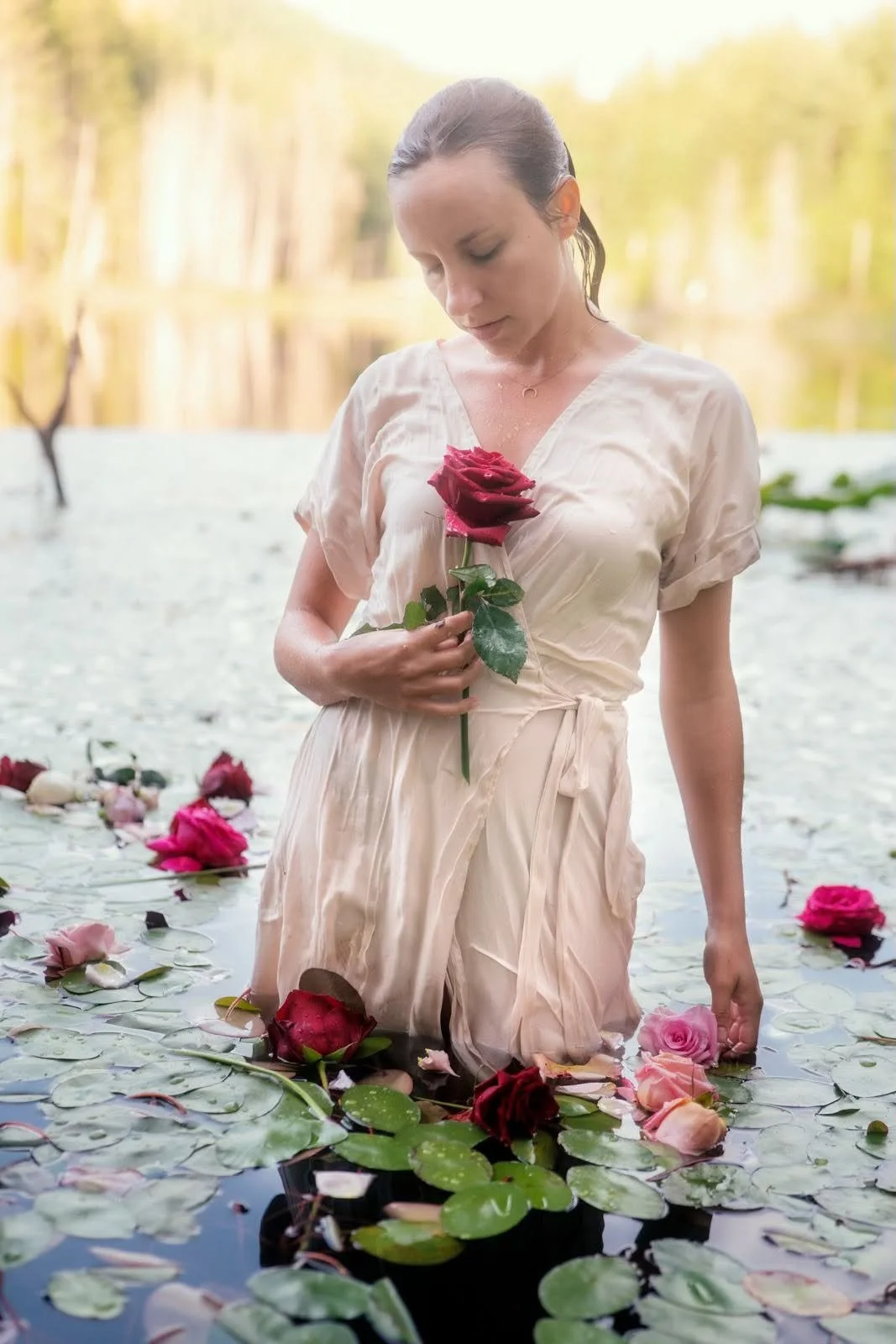 Tatiana Speed holding a rose in a lotus pond
